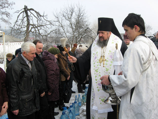 Архиепископ Полтавский и Миргородский Филипп освящает воду и окропляет прихожан святой водой