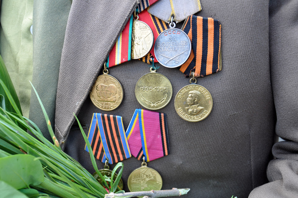 Багато присутніх були з медалями на грудях, але дійсно учасників бойових дій одиниці. У цього ветерана бачимо медаль за «Бойові заслуги», та медаль за «Перемогу» (оранжево-чорна стрічка). Ці відзнаки свідчать, що він дійсно брав участь у війні. 