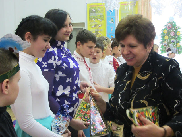 Начальник управления по делам детей Полтавской облгосадминистрации Инна Конончук вручает детям подарки