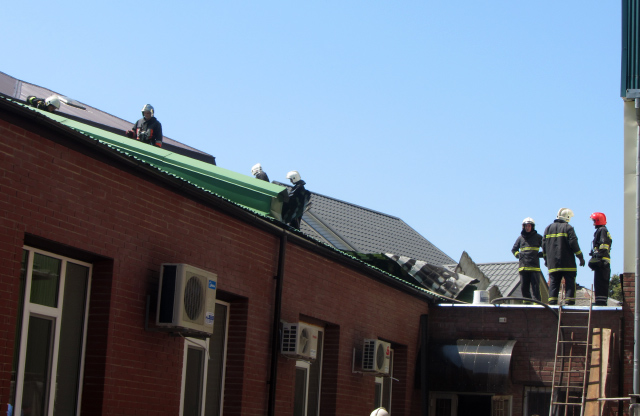 Пожежники на даху будинку