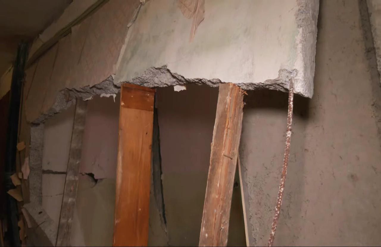 Зруйнована вибухов бетонна стіна на дерев’яних підпірках | Кадр з відео «ІРТ»